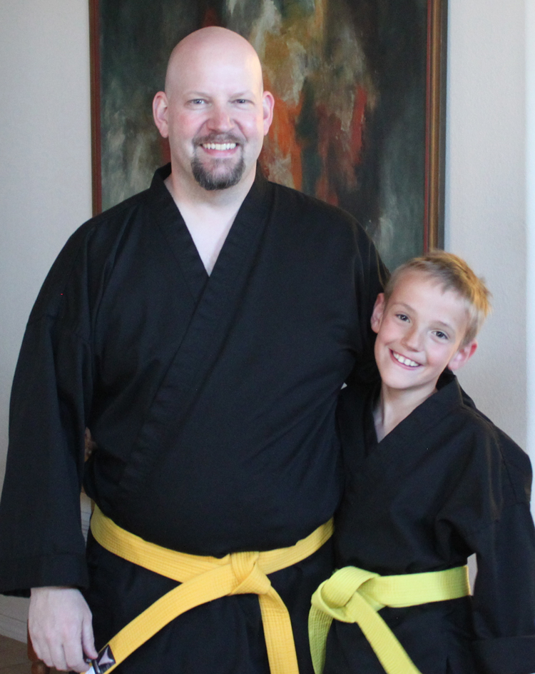 Overweight father with young son as yellow belts