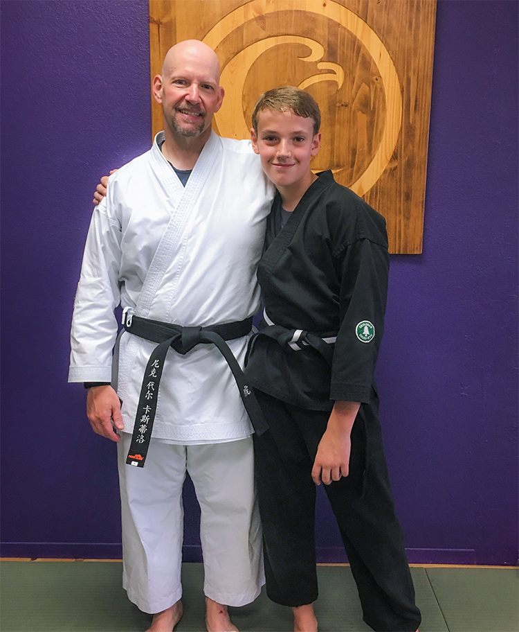 Thinner father with son four years later as black belts